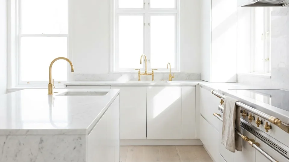 A marble kitchen at noon, counters cleared and every surface shining
